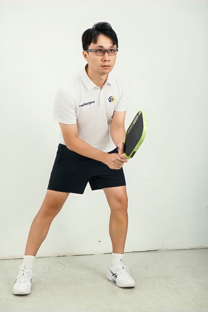 Mark Teo, certified pickleball coach in Johor Bahru, in ready position with paddle