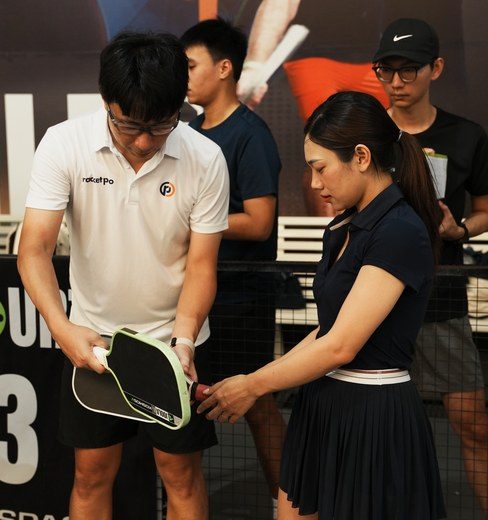 Mark Teo demonstrating shot technique to a group pickleball class in Johor Bahru